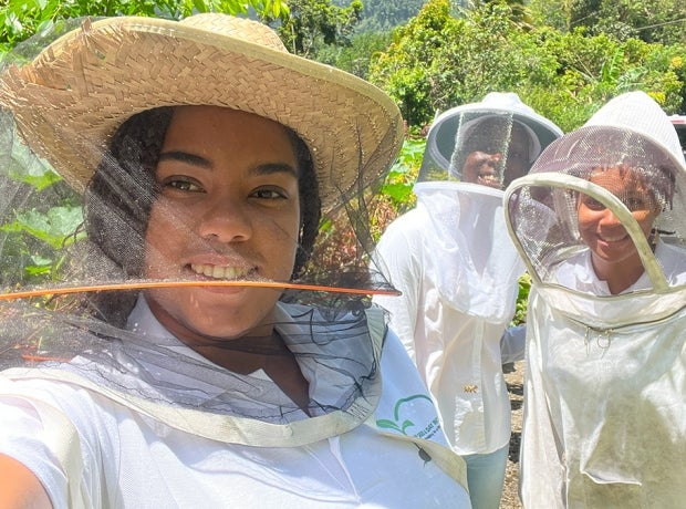 Women wearing beekeeper outfits